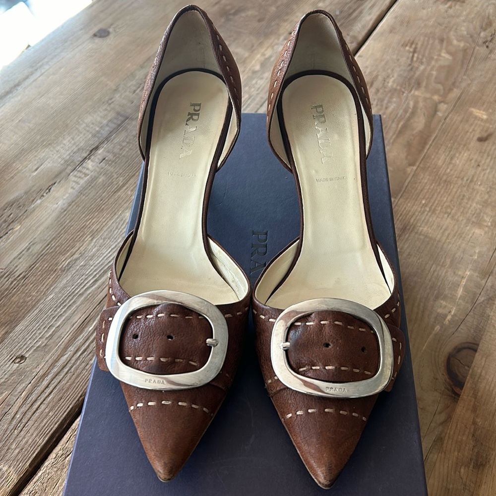 Prada low kitten heel (1 3/4”).  Gently worn. Brown leather w’ silver buckle